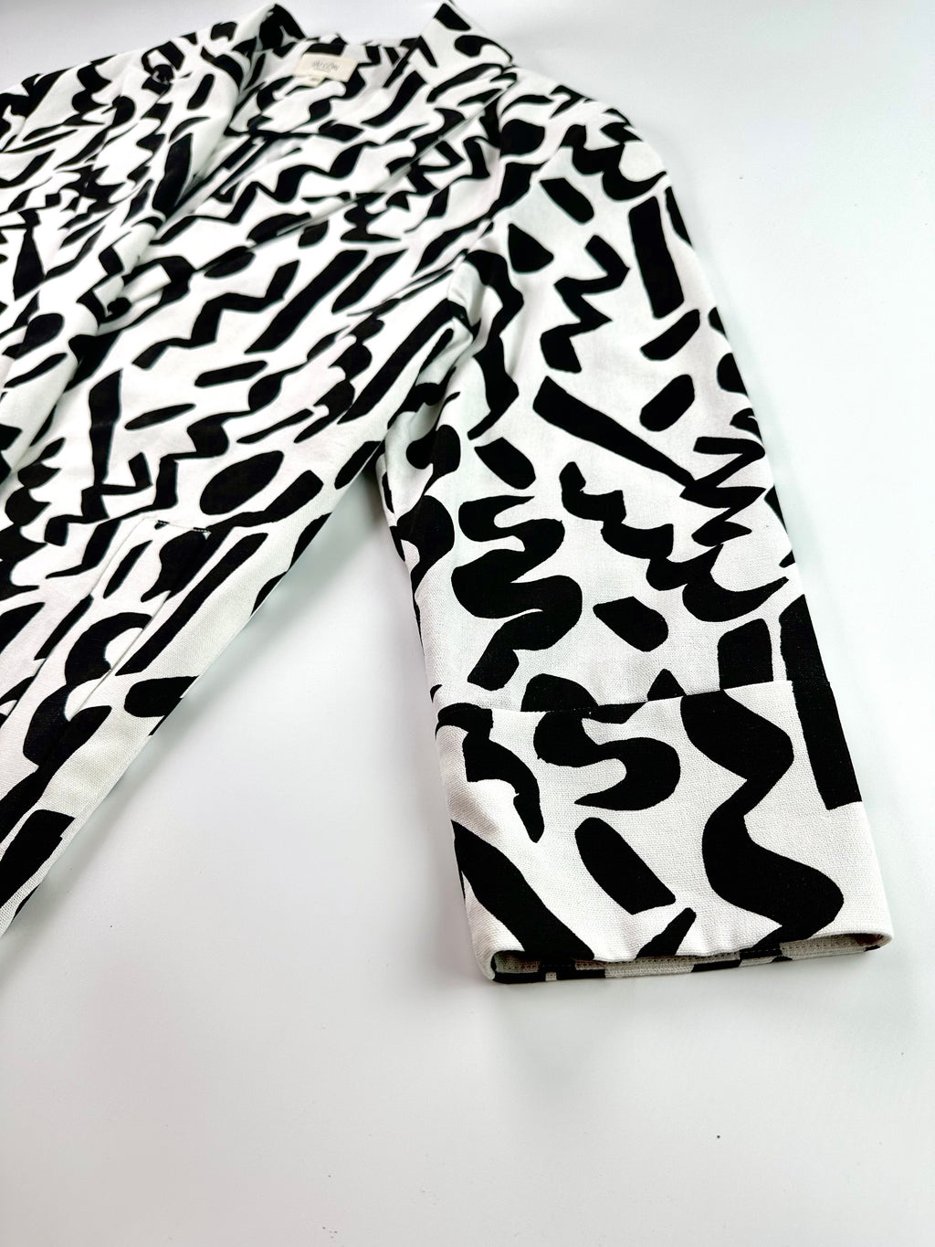 Saigon Concepts Black and white Urban Canvas patterned jacket on a light grey background - side sleeve detail view
