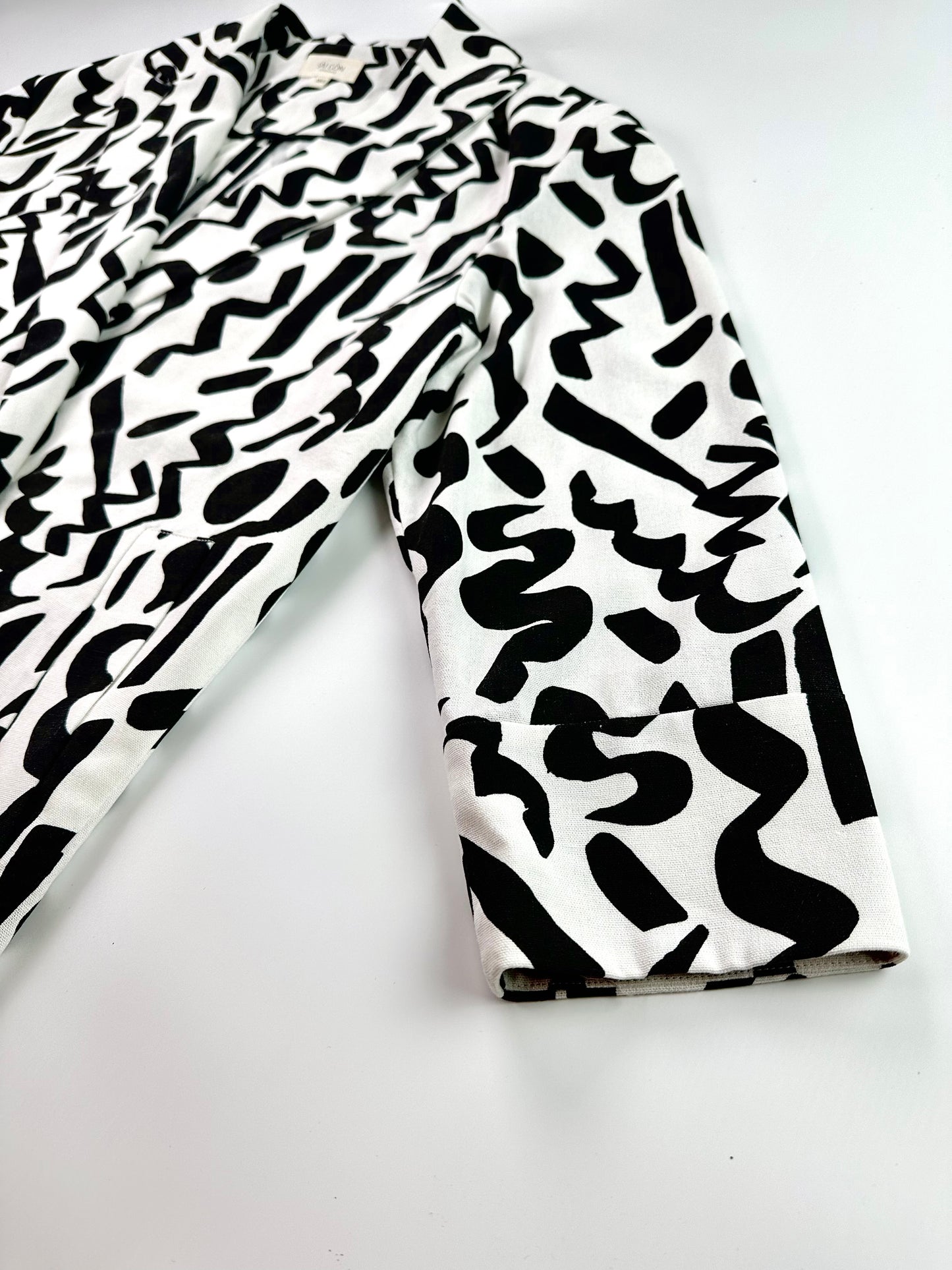 Saigon Concepts Black and white Urban Canvas patterned jacket on a light grey background - side sleeve detail view