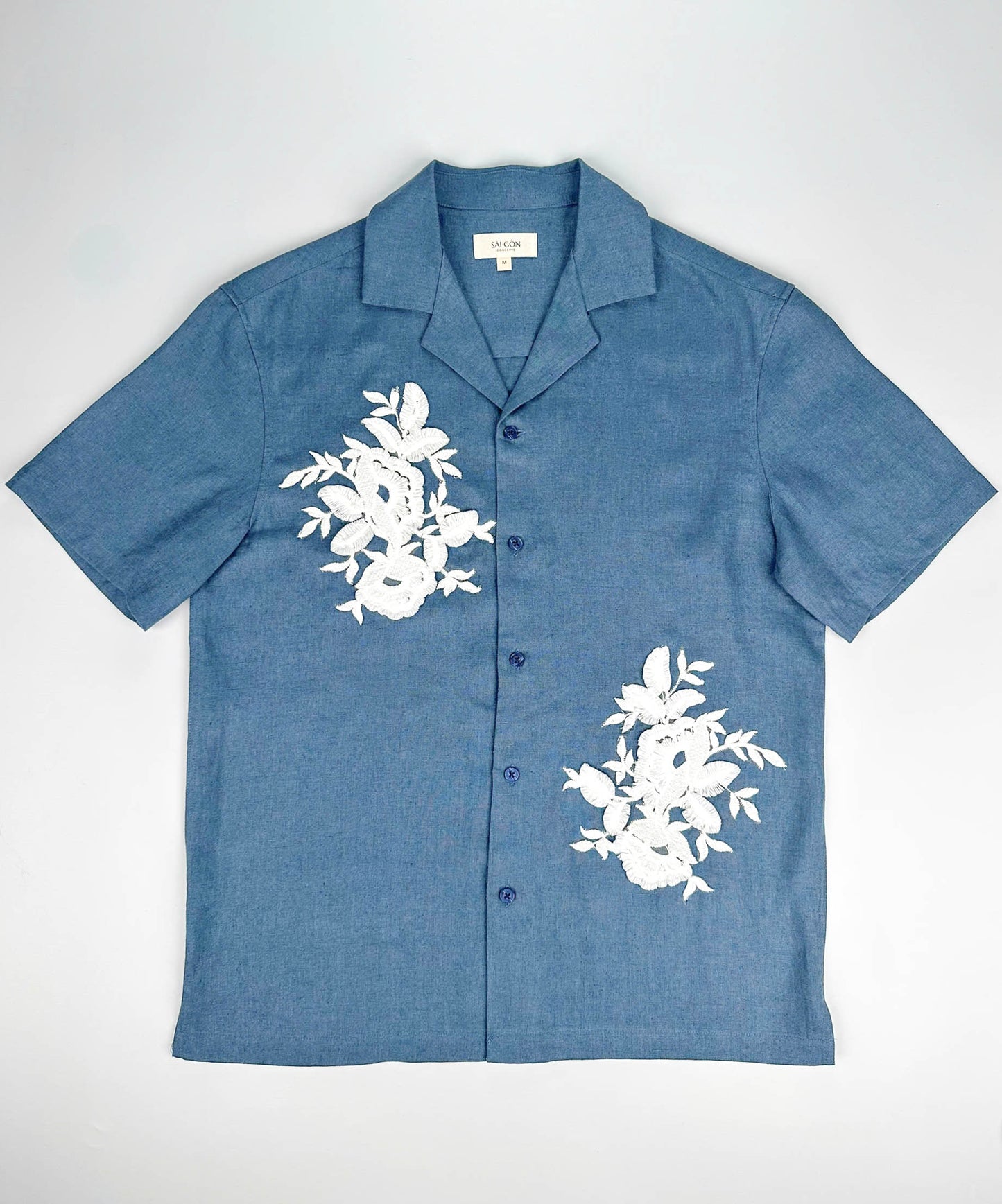 Saigon Concepts Blue Steel coloured shirt with white floral lace application on a white background