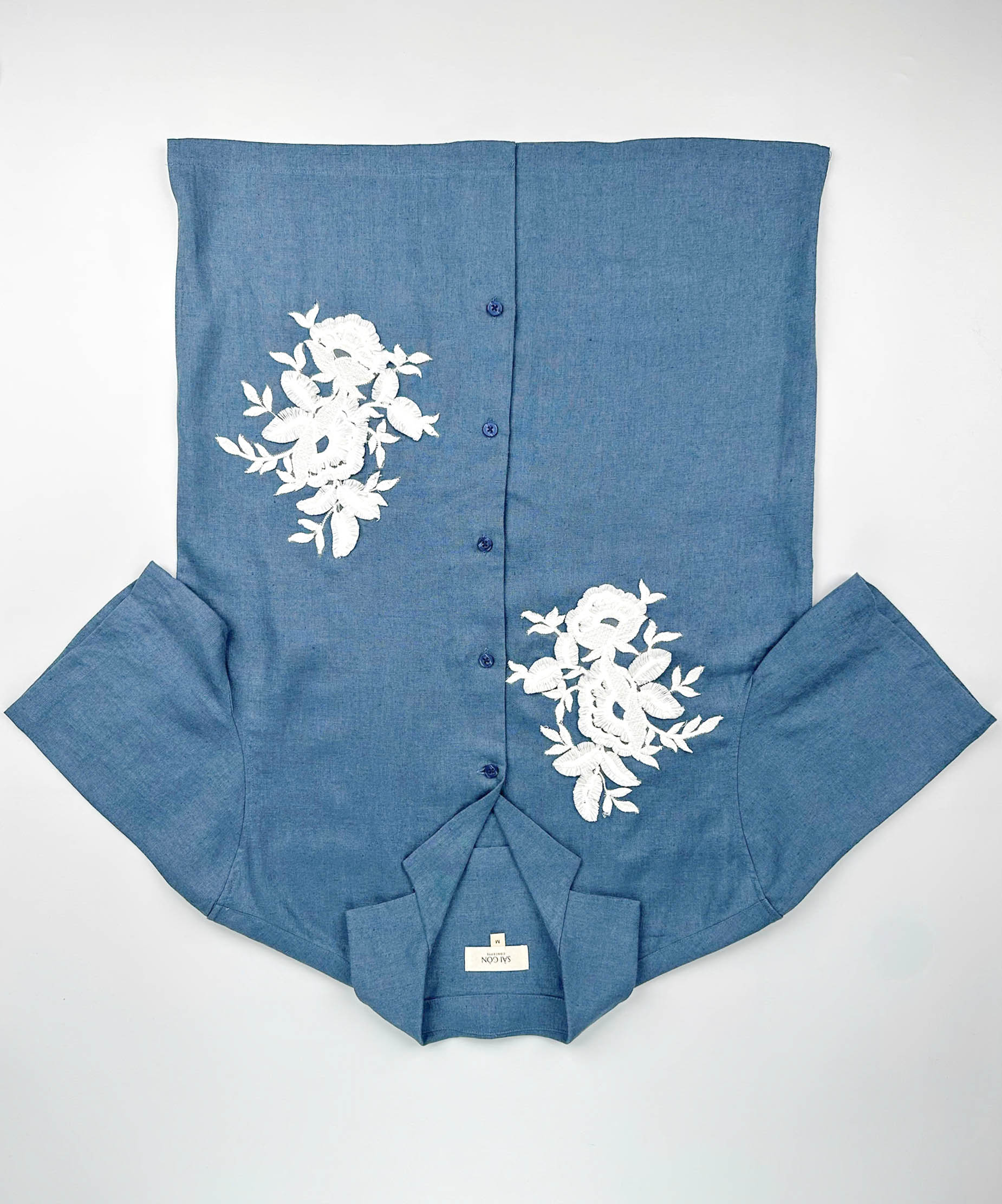 Saigon Concepts Blue Steel coloured shirt with white floral lace application on a white background