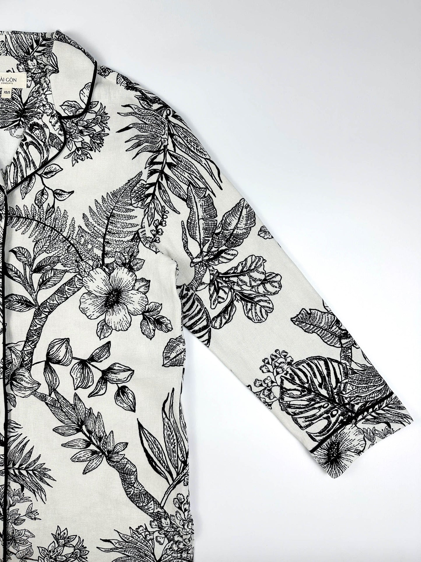 Saigon Concepts Botanical Noir Longline PJ Top with black floral etched drawing on white linen - sleeve and collar view with contrasting black piping.