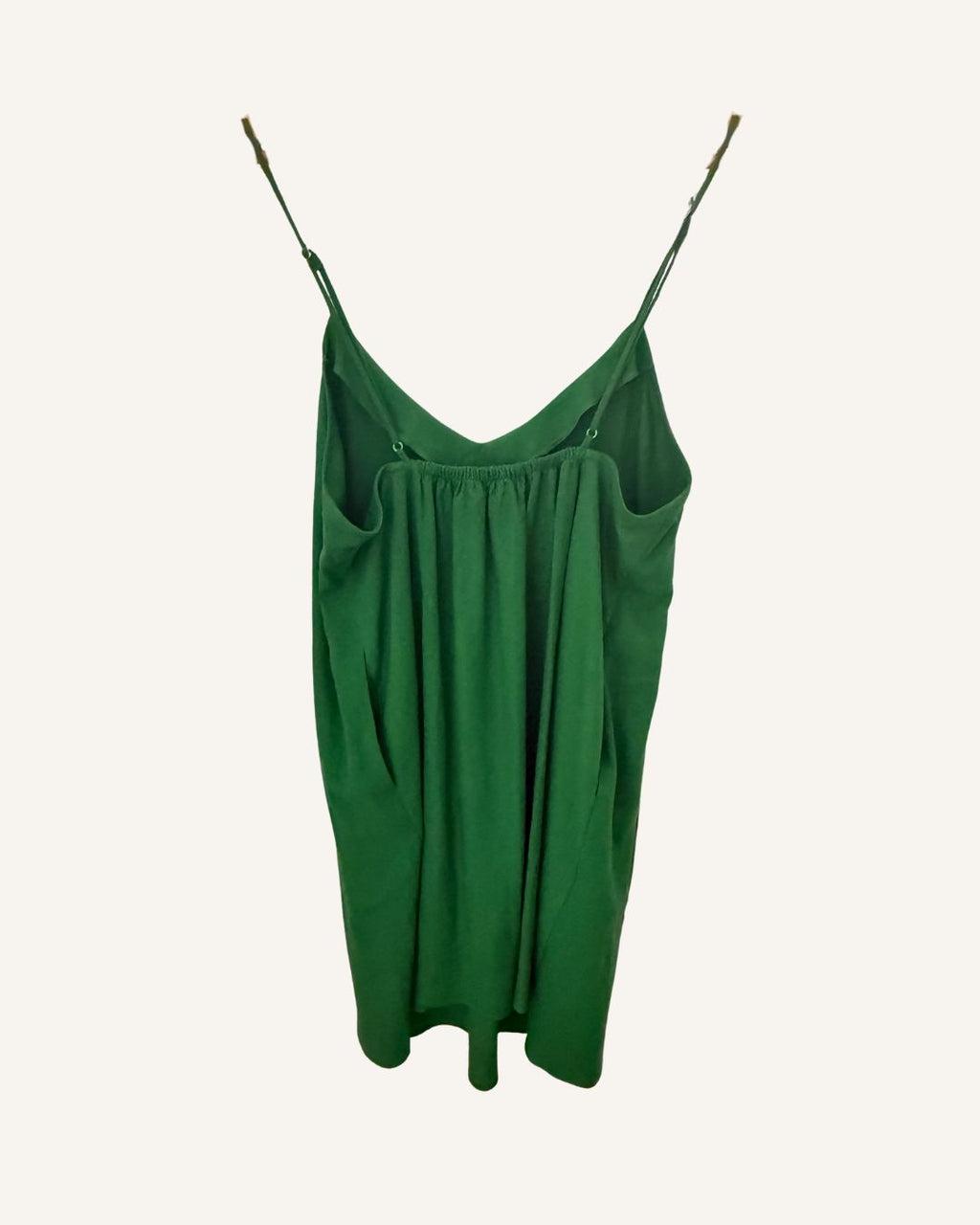 Green linen cami-slip dress on a white background