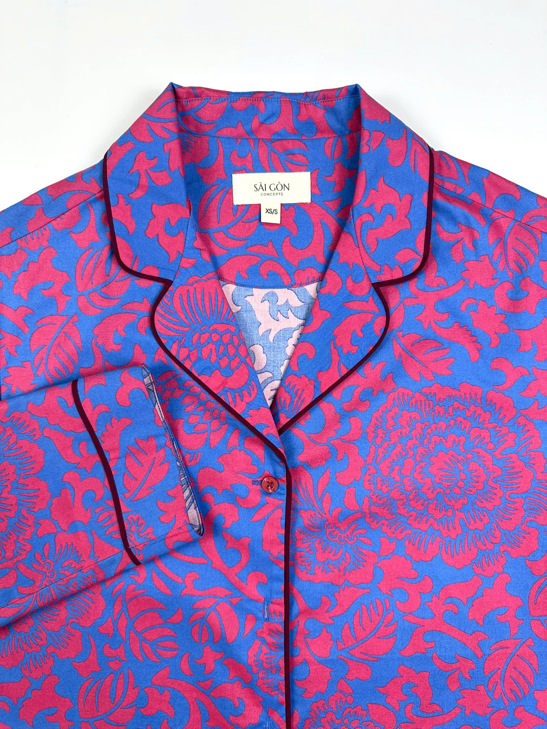 Saigon Concepts Close-up of Jardin Royale long line PJ top showing contrasting dark wine piping on collar and elegant floral print