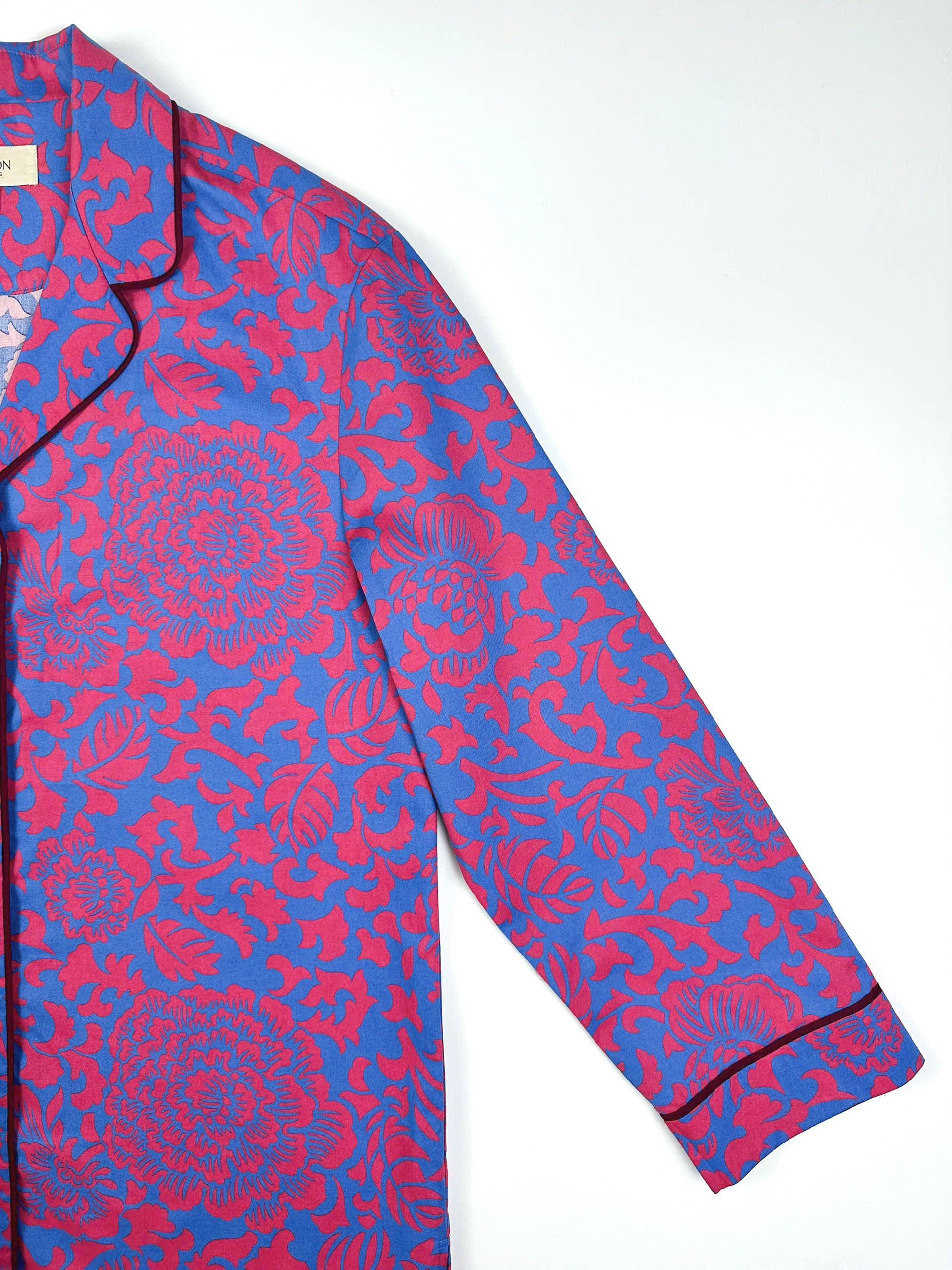 Saigon Concepts Close-up of Jardin Royale long line PJ top showing sleeve detail and contrasting dark wine piping on collar and sleeve with elegant floral print