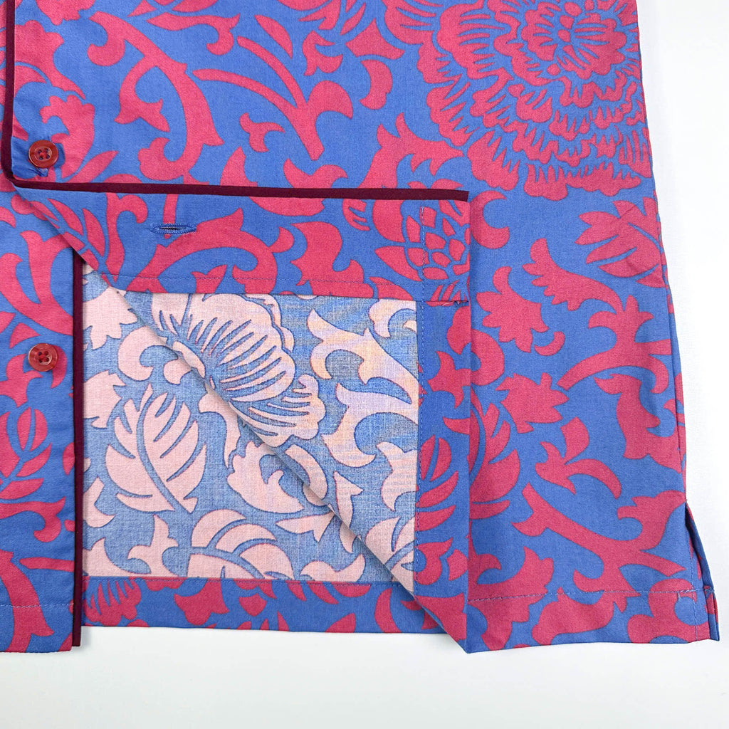 Saigon Concepts Jardin Royale lounge pyjama top in 100% cotton with red pink floral print on blue background with contrasting wine trim. Inside edge detail. Lounge to Street collection made in Vietnam