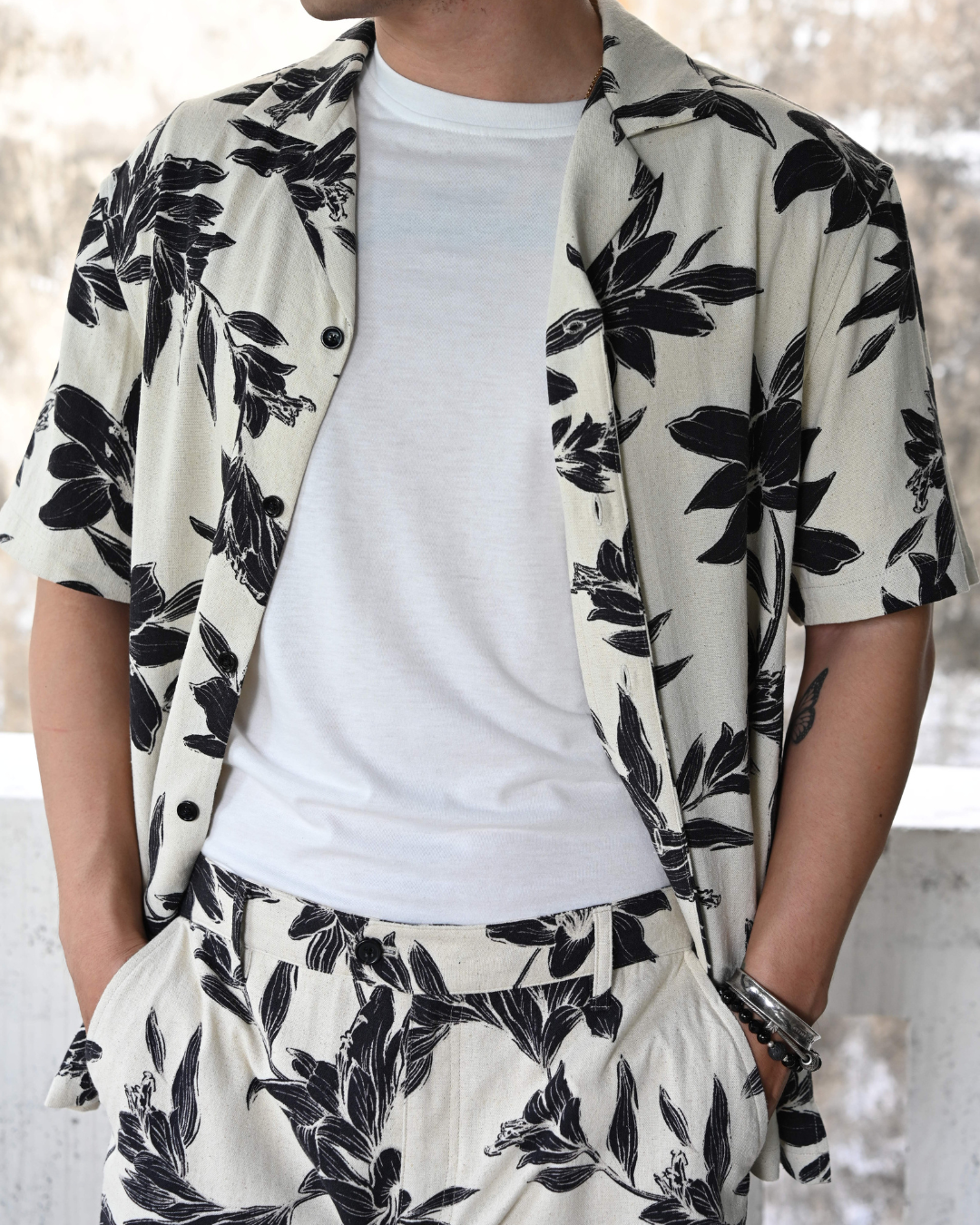 Noir Lily Hawaiian shirt in linen cotton blend with black lily print on beige background - sustainable resort wear made in Vietnam