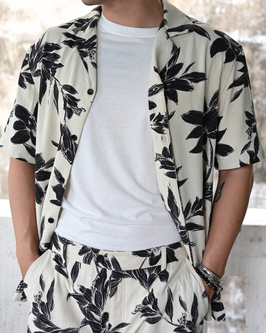 Noir Lily Hawaiian shirt in linen cotton blend with black lily print on beige background - sustainable resort wear made in Vietnam