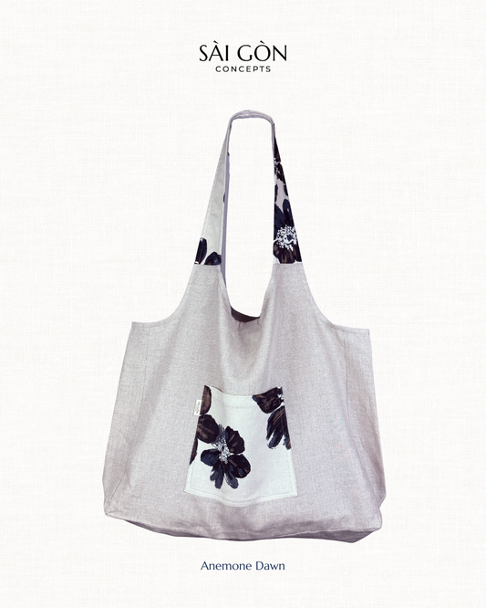 Saigon Concepts natural linen tote bag with dark navy floral hibiscus design on a white background