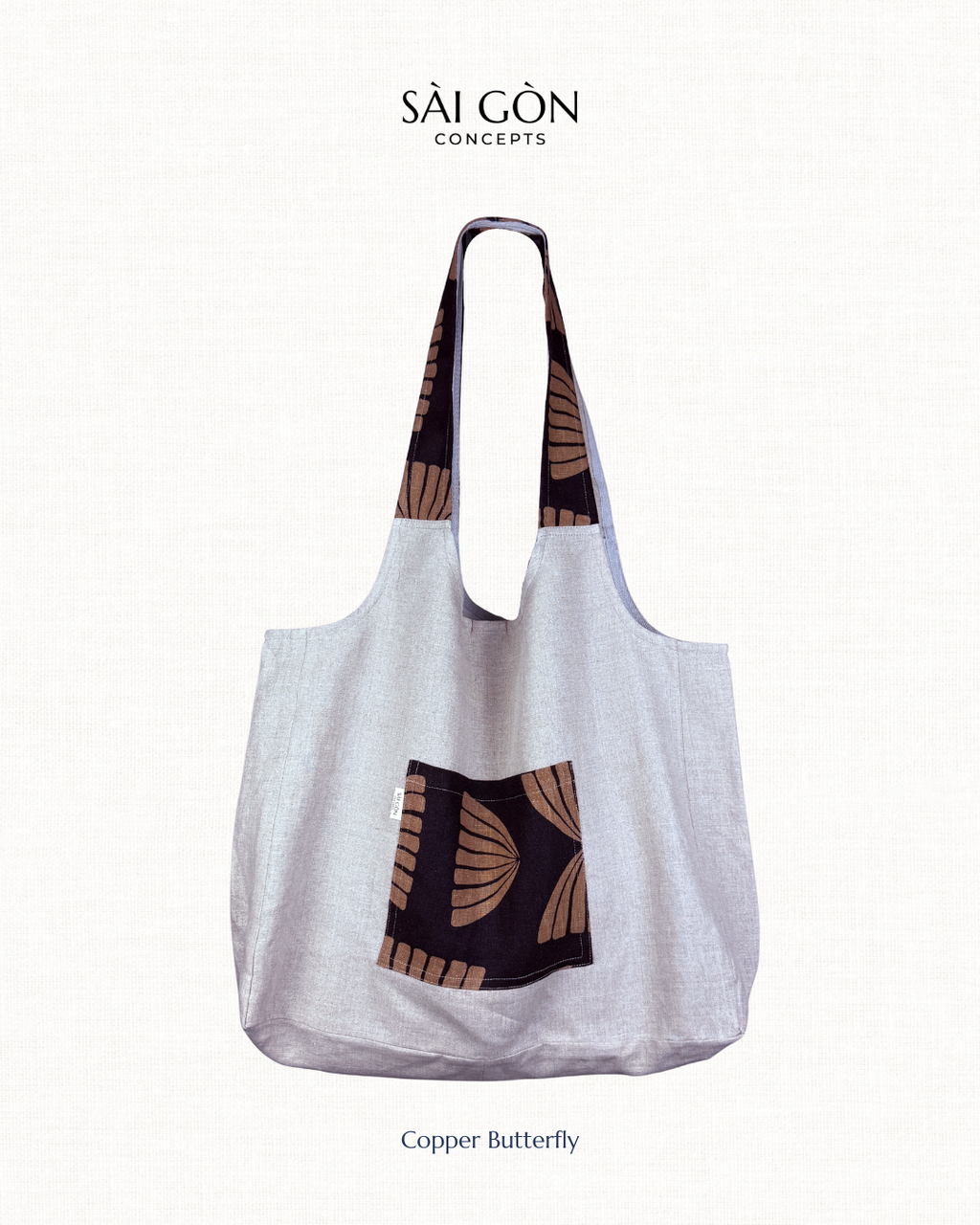 Saigon Concepts Natural Linen Beach Tote Bag with Black and Copper pocket and handle trim on a natural linen background
