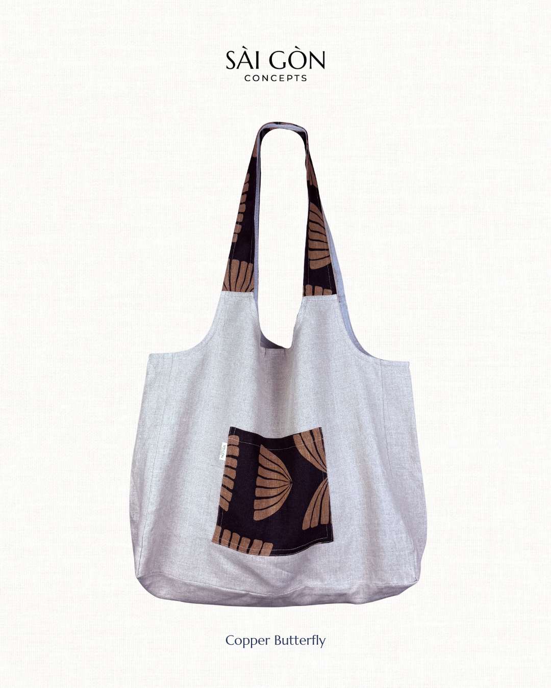 Saigon Concepts Natural Linen Beach Tote Bag with Black and Copper pocket and handle trim on a natural linen background