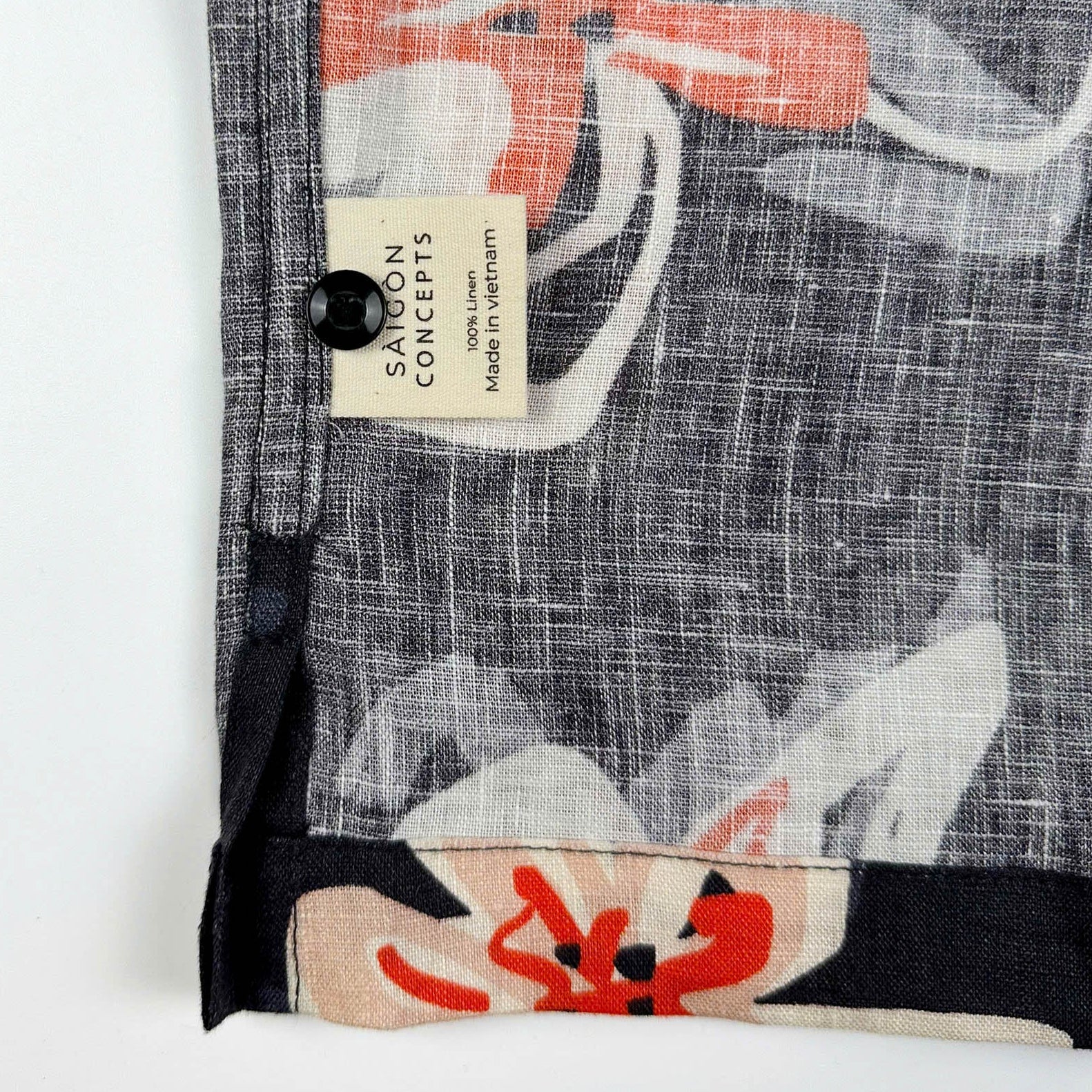 Saigon Concepts Pacific Nights Hawaiian shirt in 100% linen with abstract floral print in navy, beige, and orange-red - care label and extra button detail