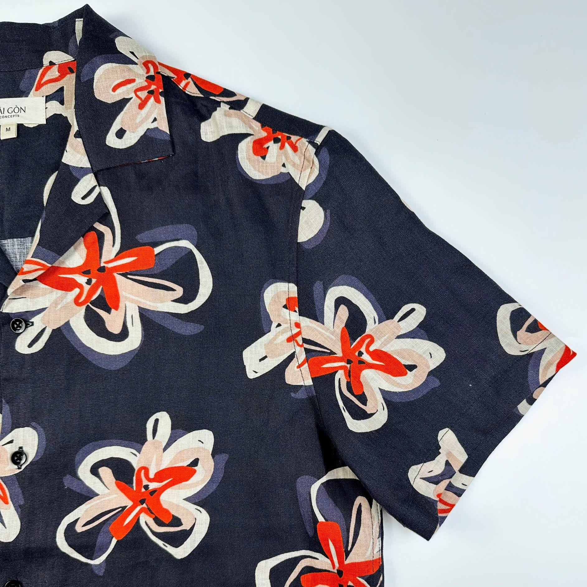 Saigon Concepts Pacific Nights Hawaiian shirt in 100% linen with abstract floral print in navy, beige, and orange-red - Sleeve detail -  sustainable resort wear made in Vietnam