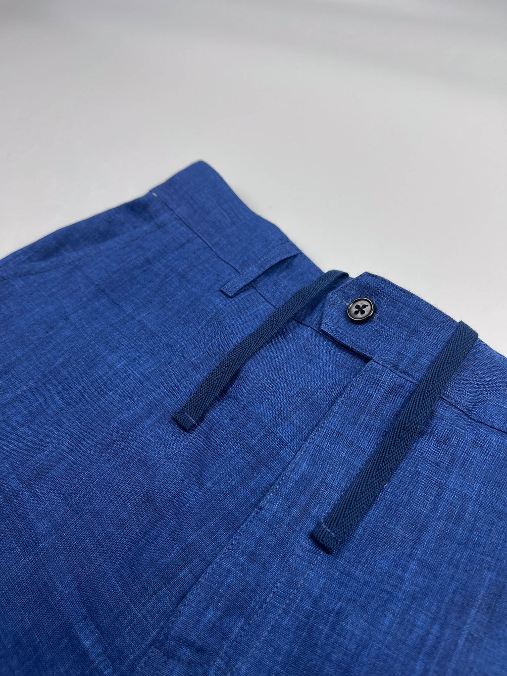 Saigon Concepts Mid Blue Riviera Linen Shorts - flat front view with button closure and inner drawstring detail