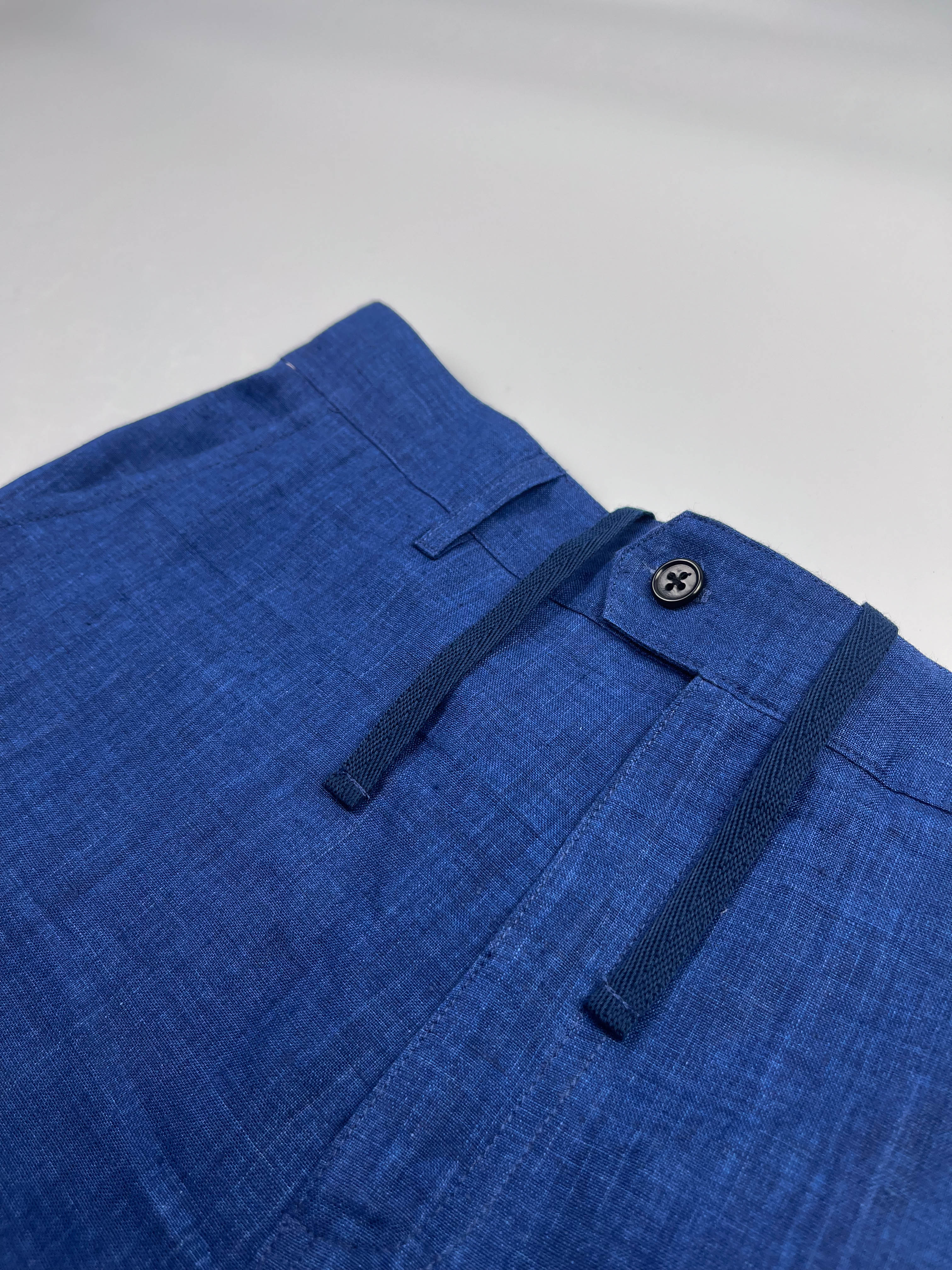 Saigon Concepts Mid Blue Riviera Linen Shorts - flat front view with button closure and inner drawstring detail