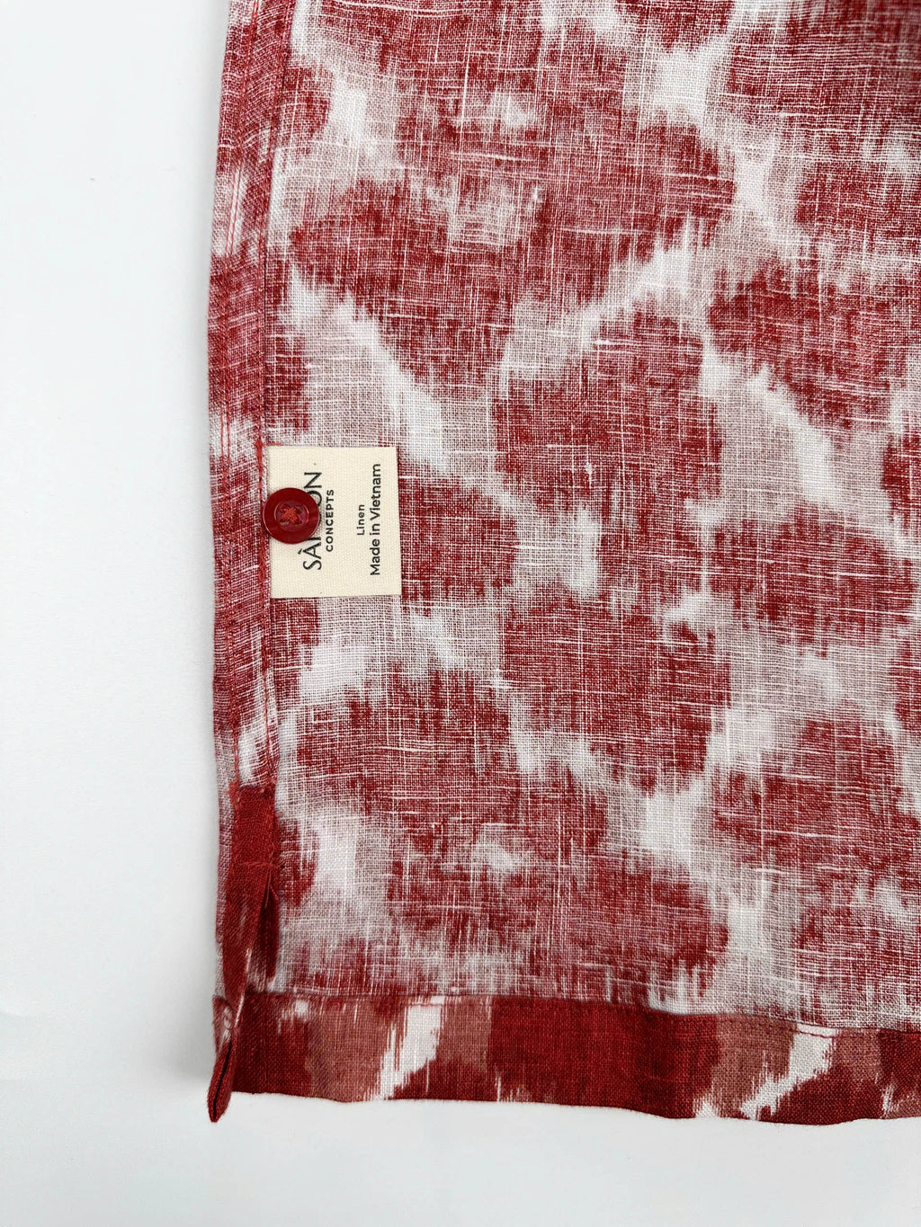 Saigon Concepts Hawaiian Shirt with Red ink blot patterned shirt on a white background - care label with spare button view