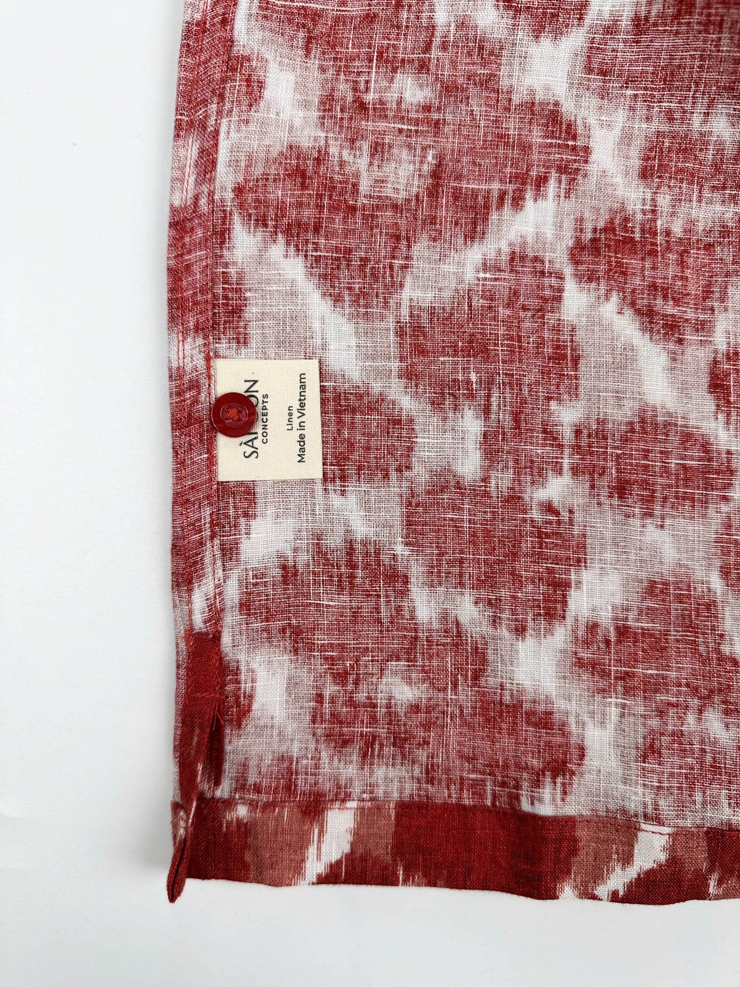 Saigon Concepts Hawaiian Shirt with Red ink blot patterned shirt on a white background - care label with spare button view