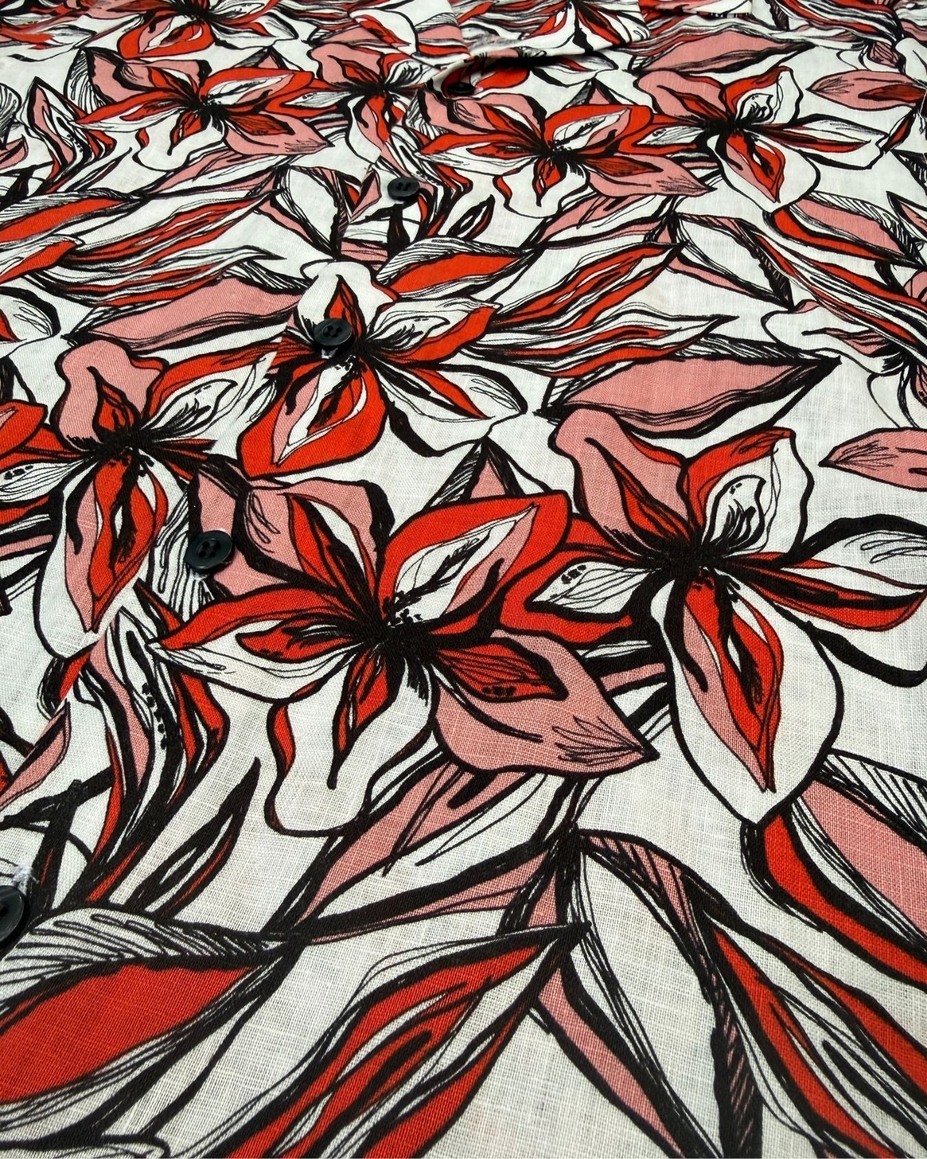 Red and black floral patterned Hawaiian shirt - close up fabric detail view