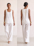 Woman wearing Saigon Concepts Aria linen tank tank top in white colour showing front and back view with overlap flap back detail to keep you cool.