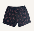 Flat lay of dark shorts with a pink flamingo print