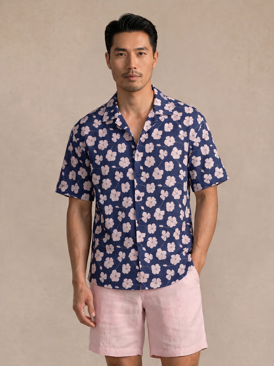 Man wearing a navy short-sleeve shirt with a white floral print, front view