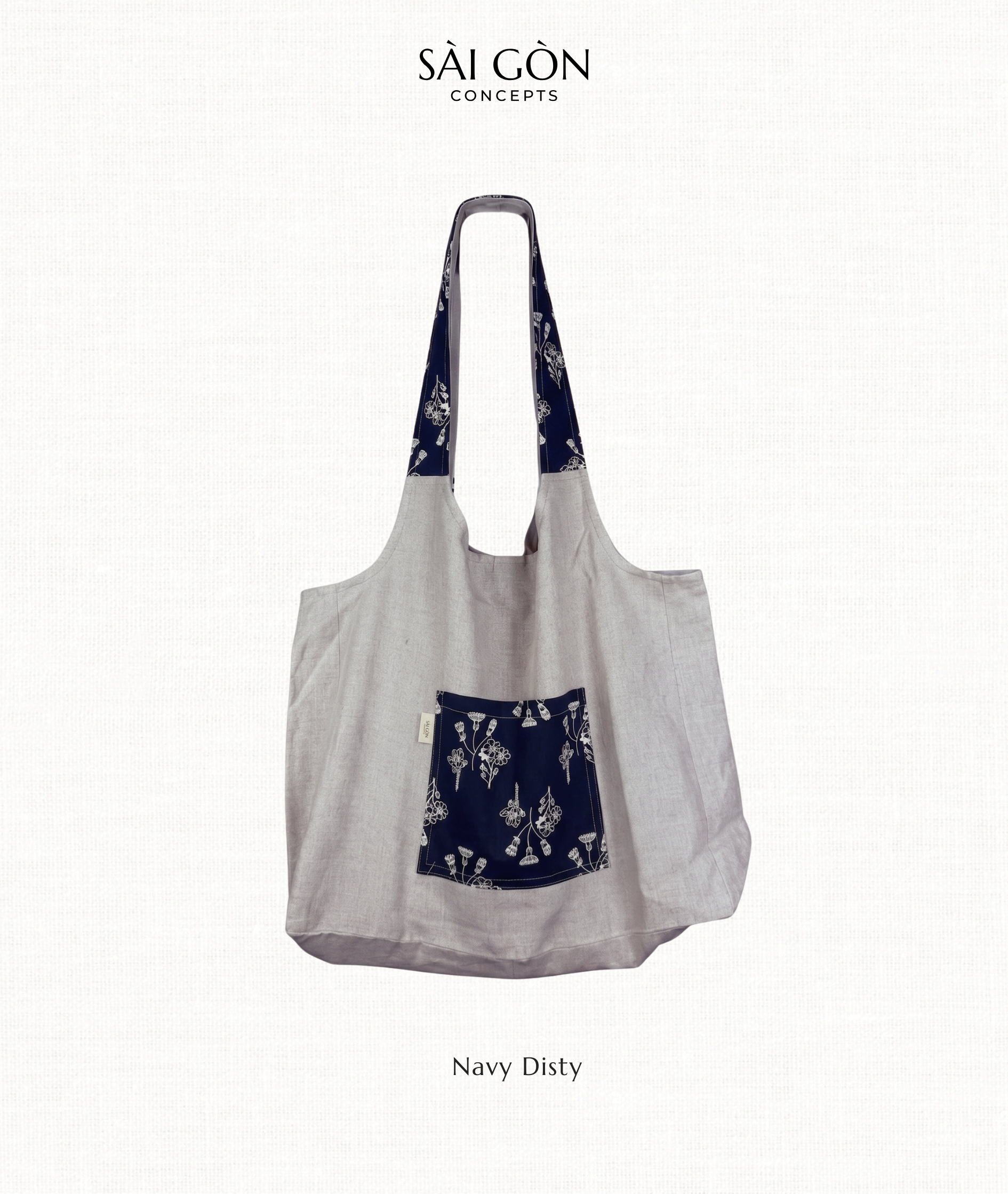Natural linen tote bag with a navy floral ditsy print pocket panel, Saigon Concepts label