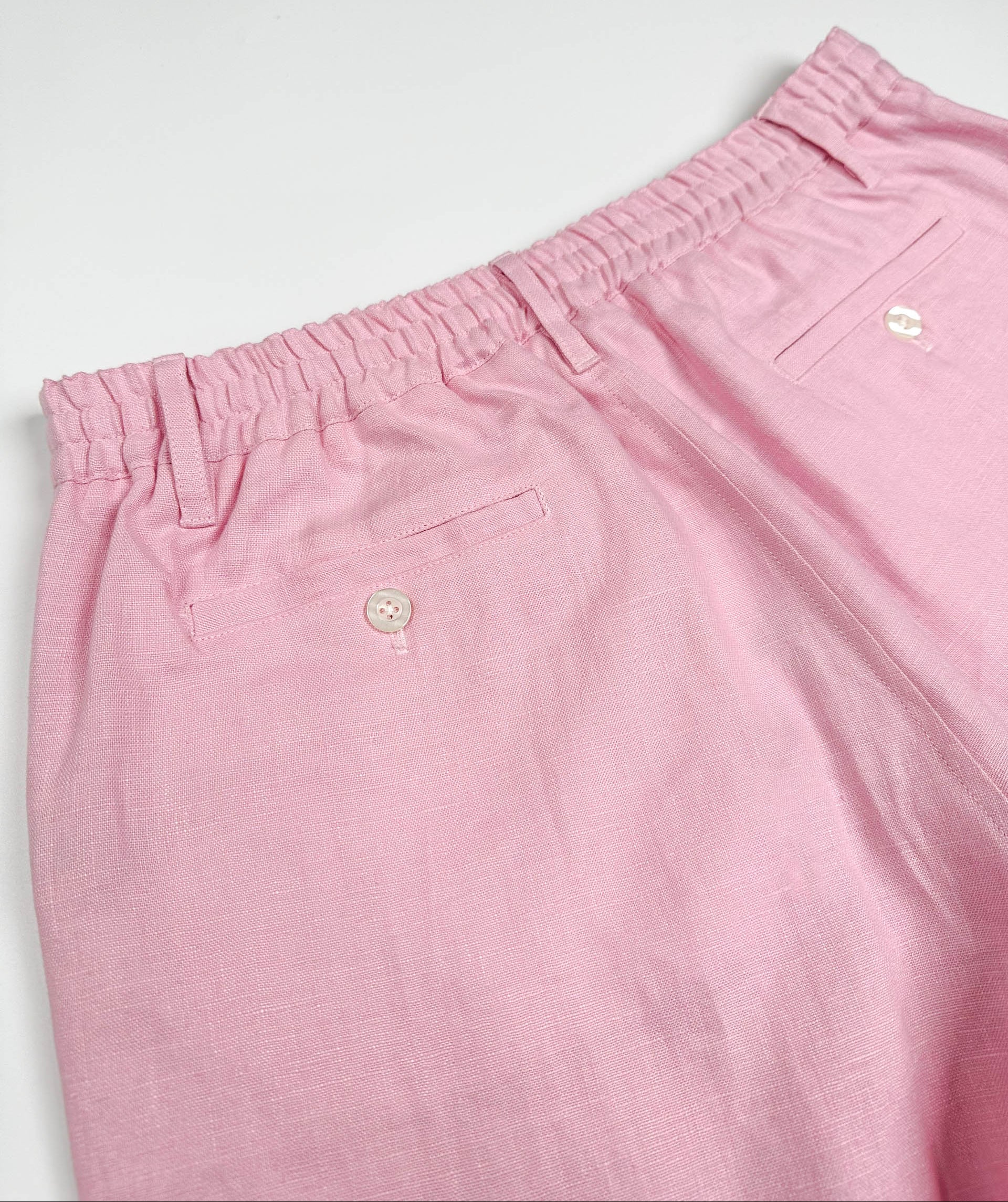 Saigon Concepts blush pink linen shorts - elasticated back and two back pockets with button closure detail view
