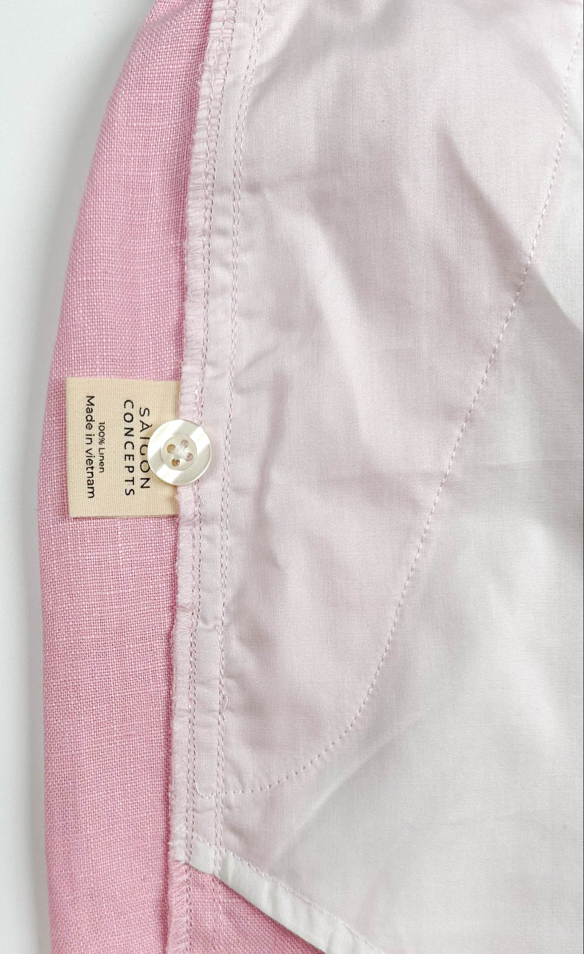Saigon concepts blush pink linen shorts - inside care label and spare button detail view
