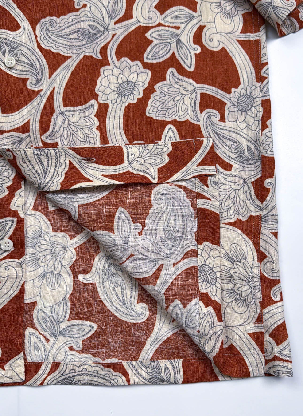 Saigon Concepts Annam Vine Hawaiian Shirt with white etched floral print on rust-orange linen fabric - seam detail view