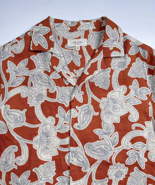 Saigon Concepts Annam Vine Hawaiian Shirt with white edged floral print on rust-orange linen fabric - lay flat front neck view