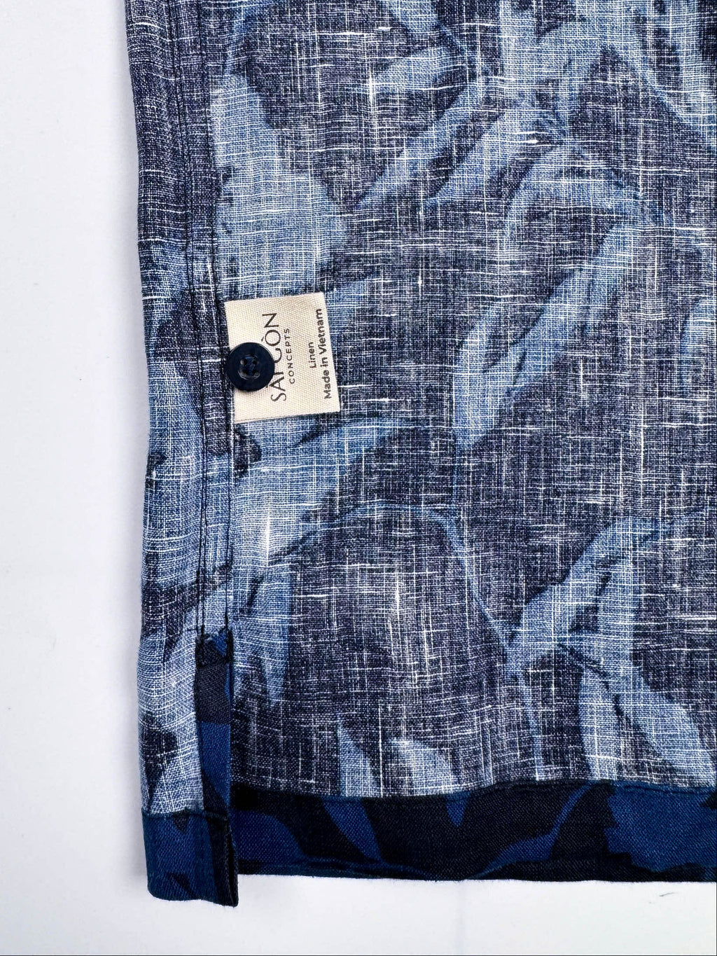 Saigon Concepts Hawaiian Shirt with blue leaf patterned print on a dark navy linen - inside care label detail