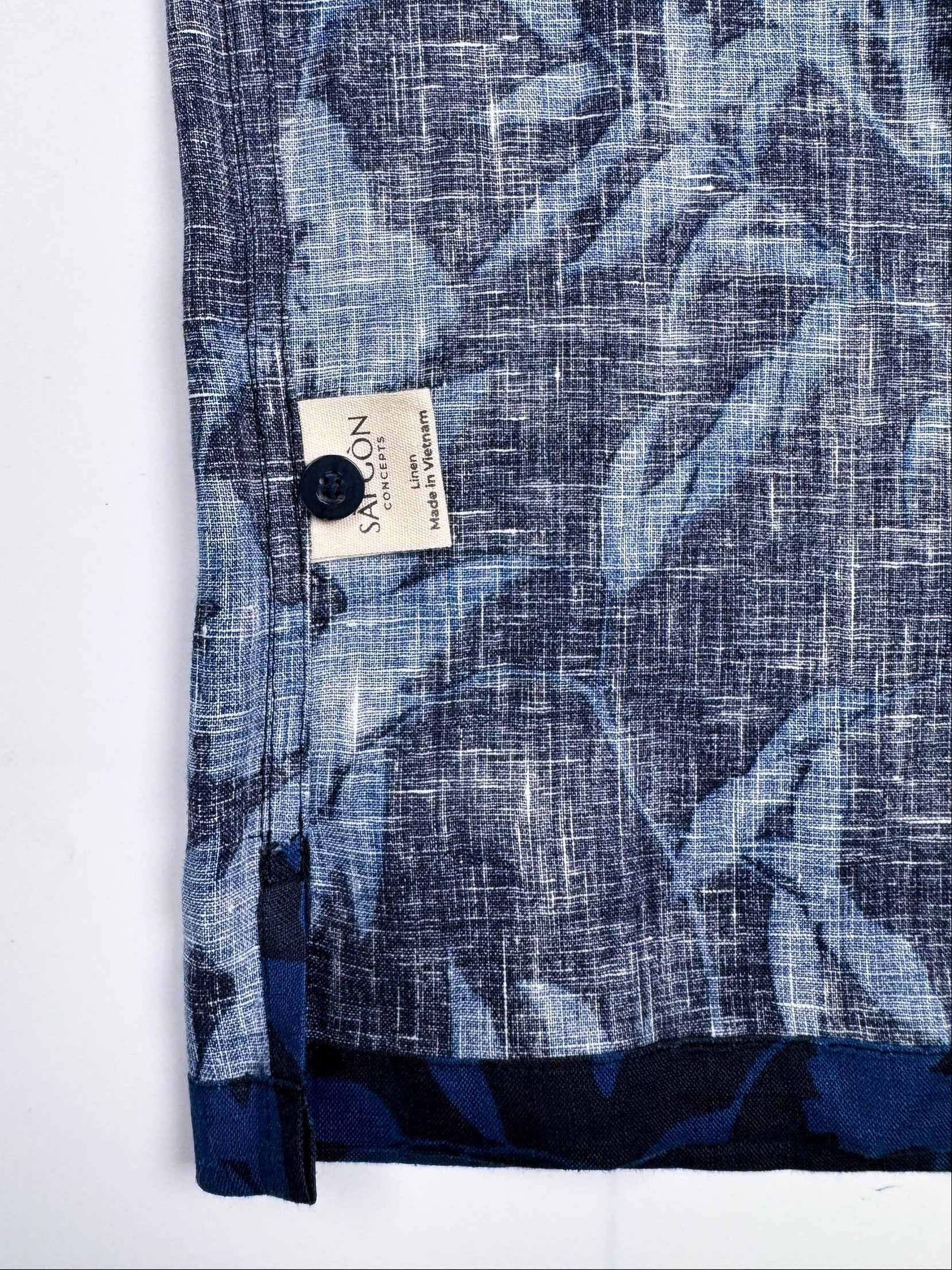 Saigon Concepts Hawaiian Shirt with blue leaf patterned print on a dark navy linen - inside care label detail