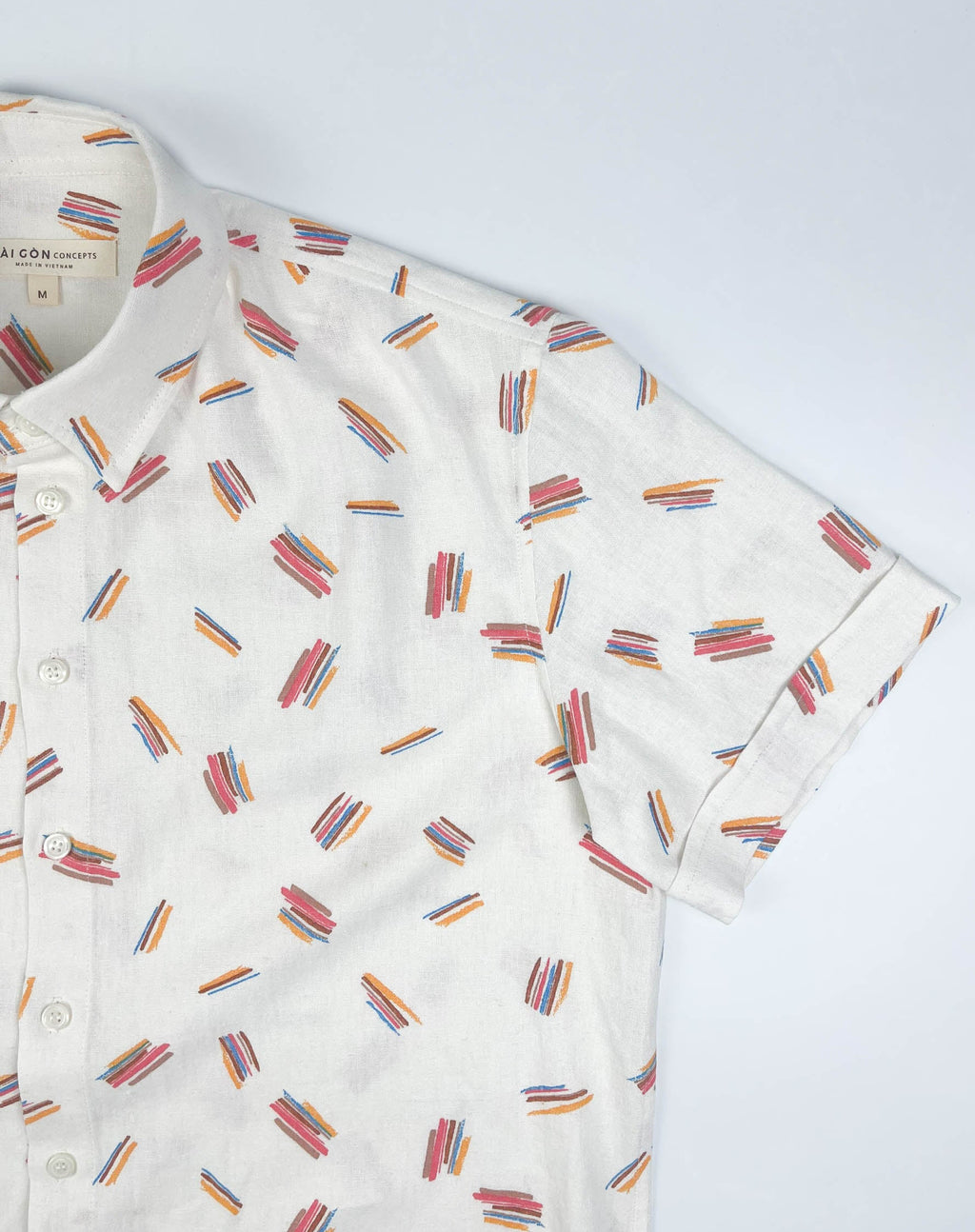 Crayon Strokes on natural white linen fabric, short sleeve button-up shirt lay flat sleeve detail view