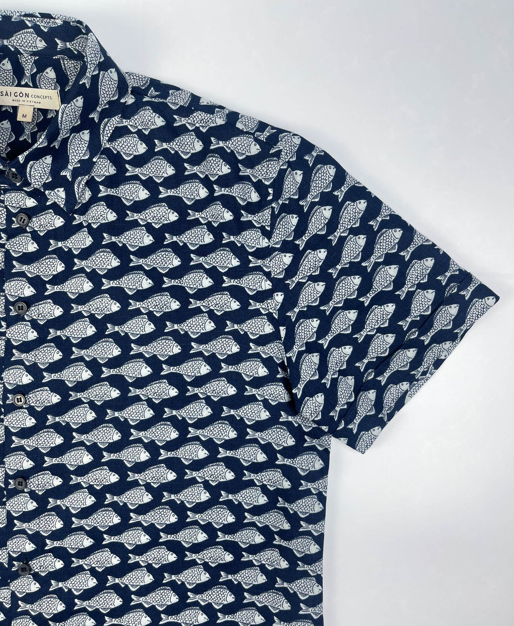 Darkwave Shoal linen short sleeve button-up shirt lay flat sleeve detail view, white fish shoal print on navy