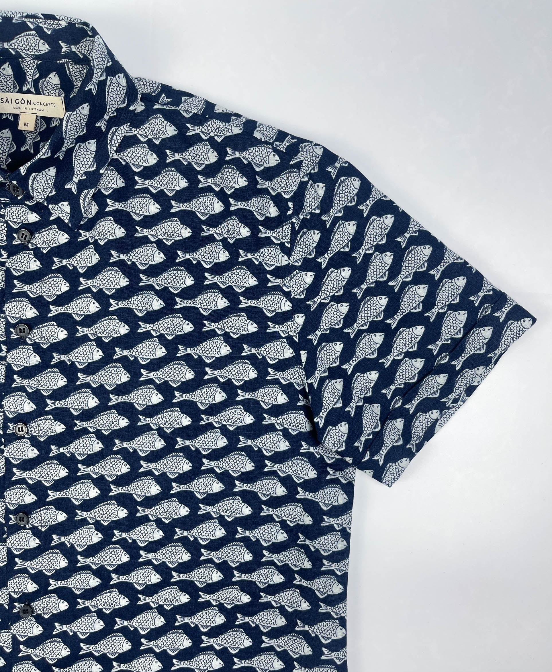 Darkwave Shoal linen short sleeve button-up shirt lay flat sleeve detail view, white fish shoal print on navy