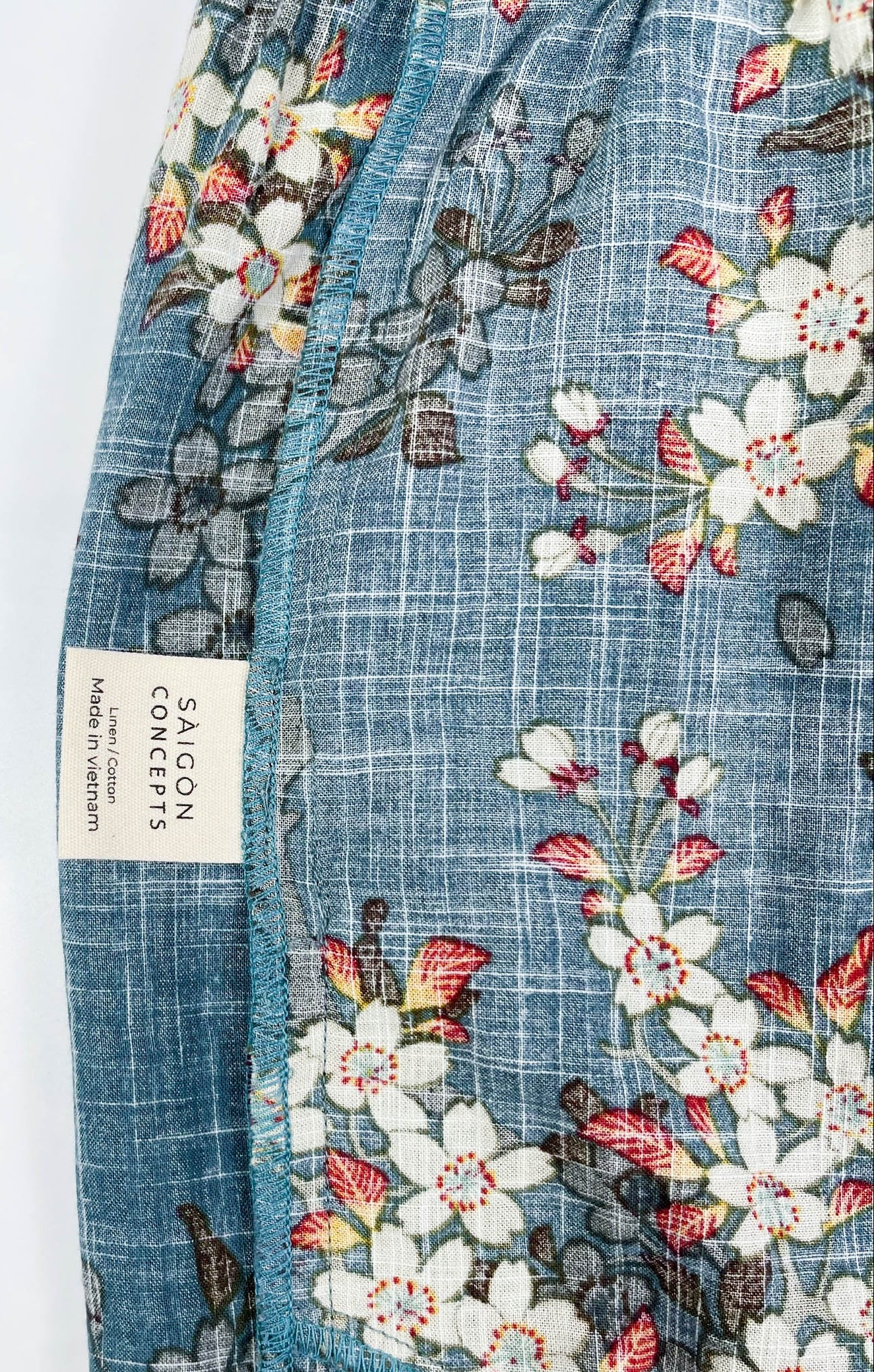 Care label detail view - Long Pyjama pants in Teal Blue cotton-linen fabric with delicate white blossom print - Saigon Concepts