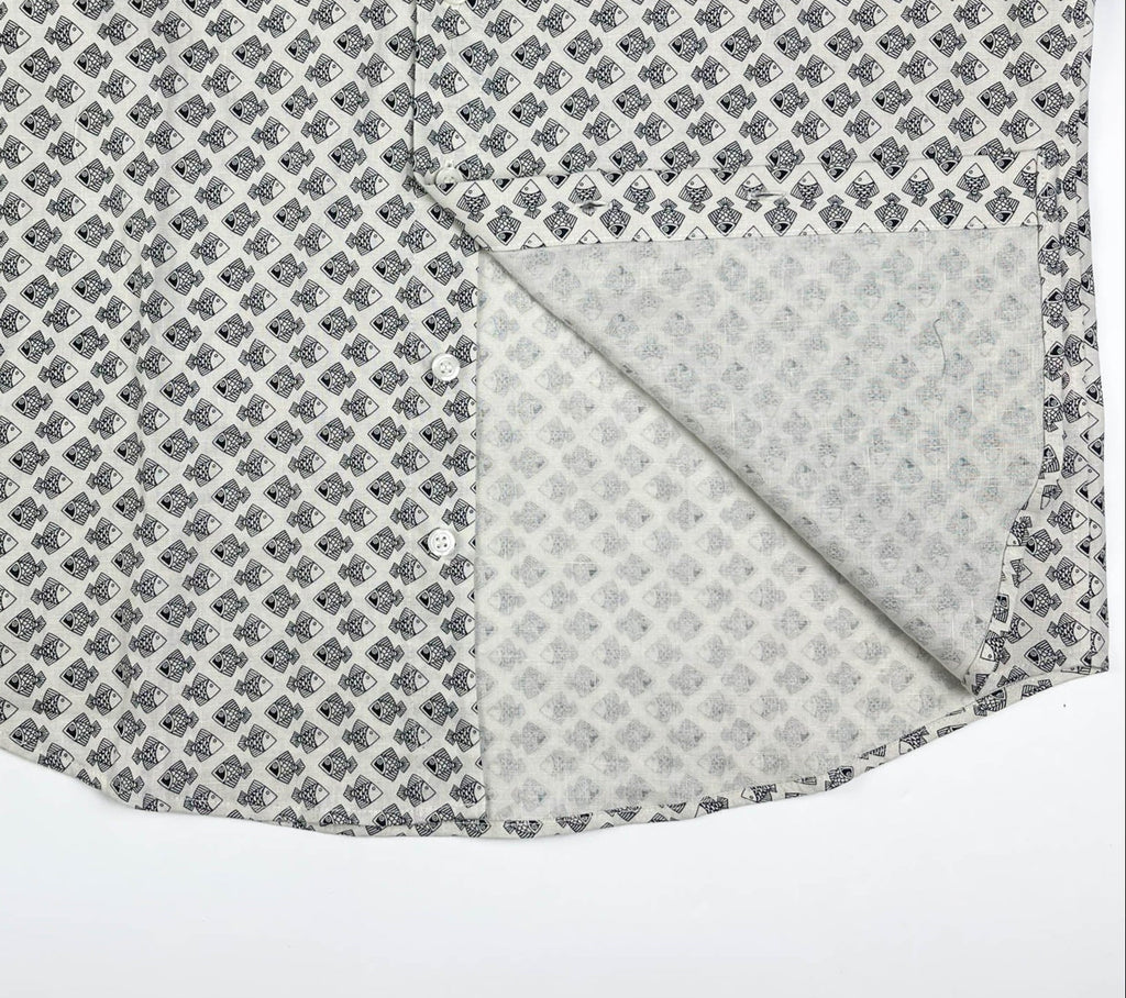 Tiny Black Fish linen long sleeve button-up shirt lay flat inside seam detail view, small fish print on natural white base