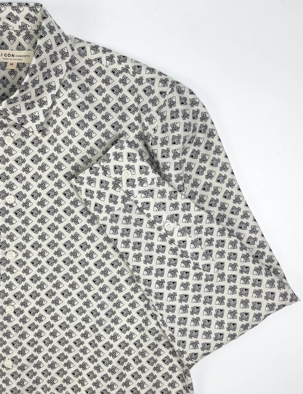 Tiny Black Fish linen long sleeve button-up shirt lay flat sleeve detail view, small fish print on natural white base