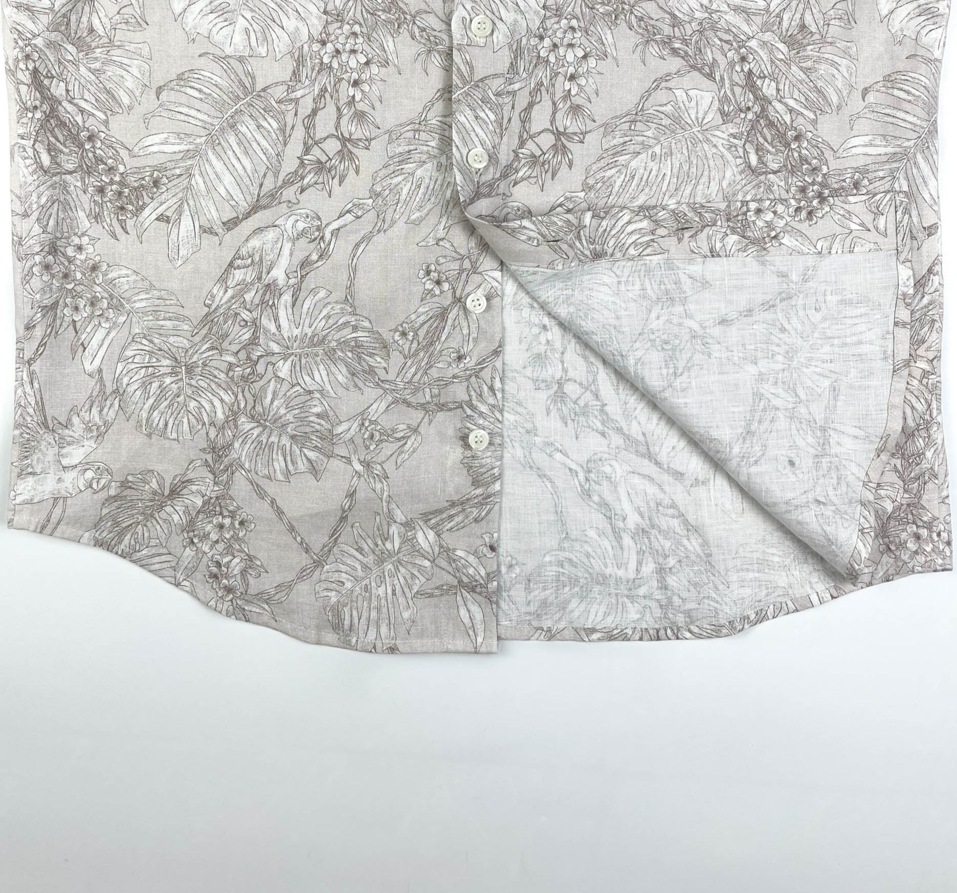 Tropicana Parrot long sleeve button-up shirt lay flat inside seam detail view, parrot and foliage print on natural white linen