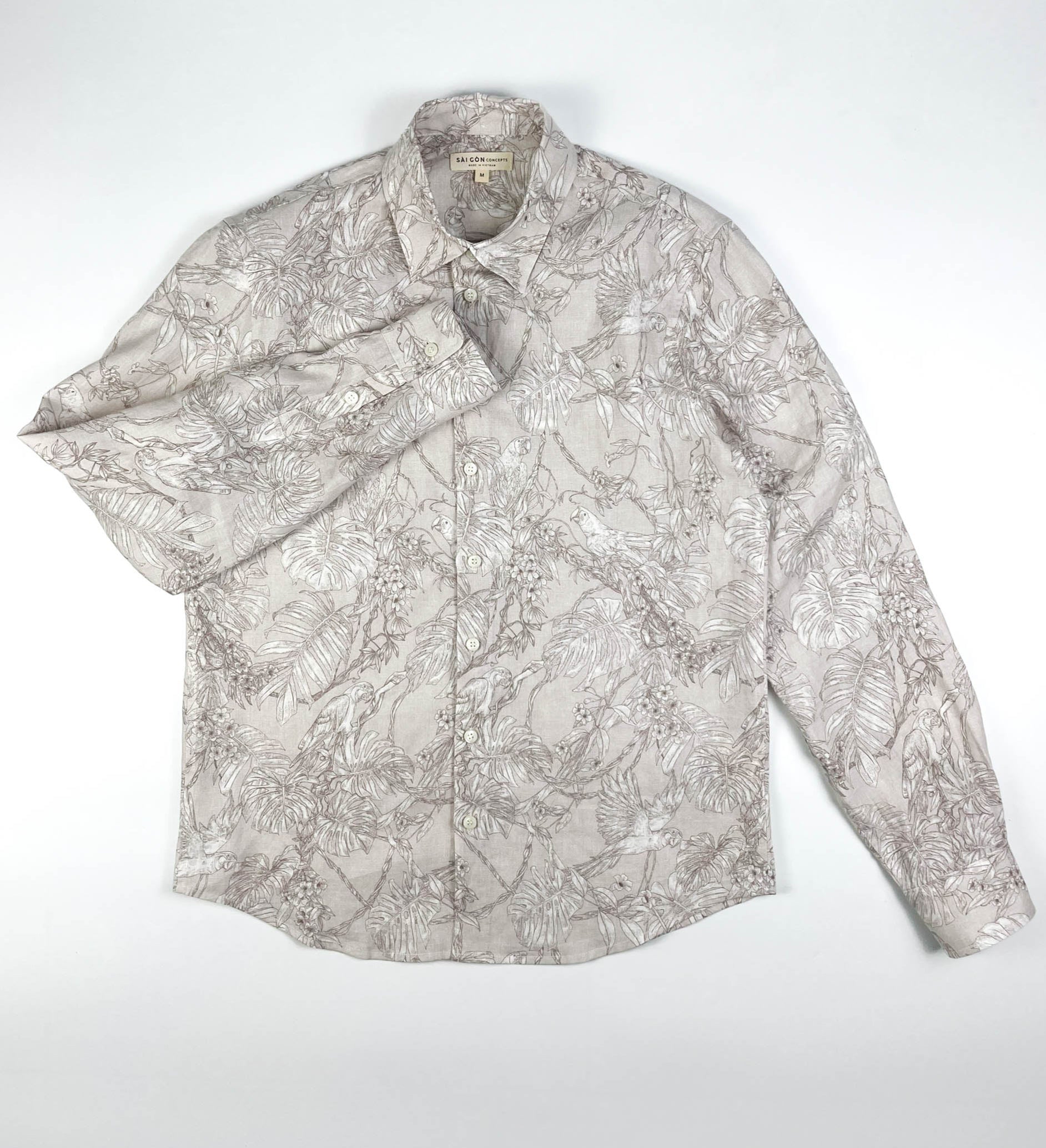 Tropicana Parrot long sleeve button-up shirt lay flat full front view, parrot and foliage print on natural white linen
