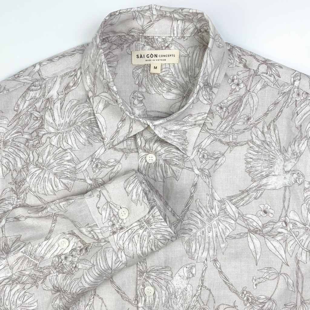Tropicana Parrot long sleeve button-up shirt lay flat collar detail view, parrot and foliage print on natural white linen