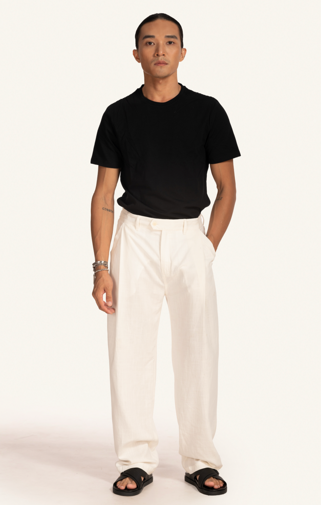 Man wearing Saigon Concepts White Linen Pants with Black Tee