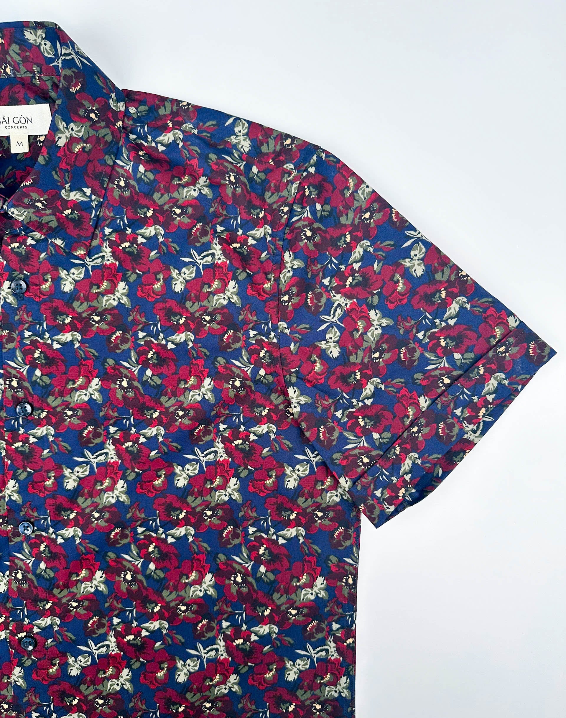Wild Burgundy cotton short sleeve button-up shirt lay flat sleeve detail view, burgundy floral print on navy blue.
