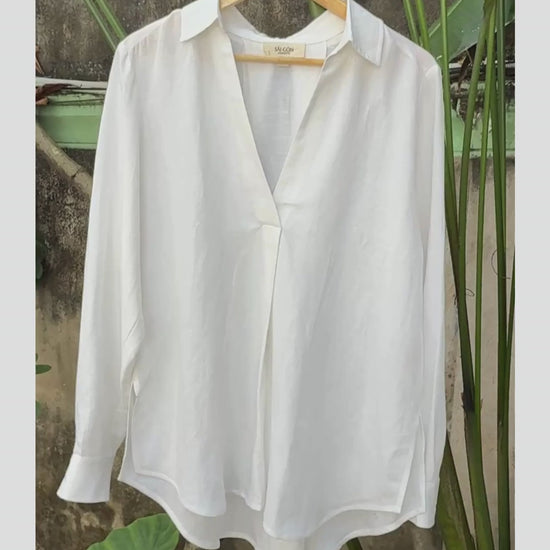 Video showing Saigon Concepts White Linen-mix v-neck long sleeve blouse on hanger in garden showing front view detail 