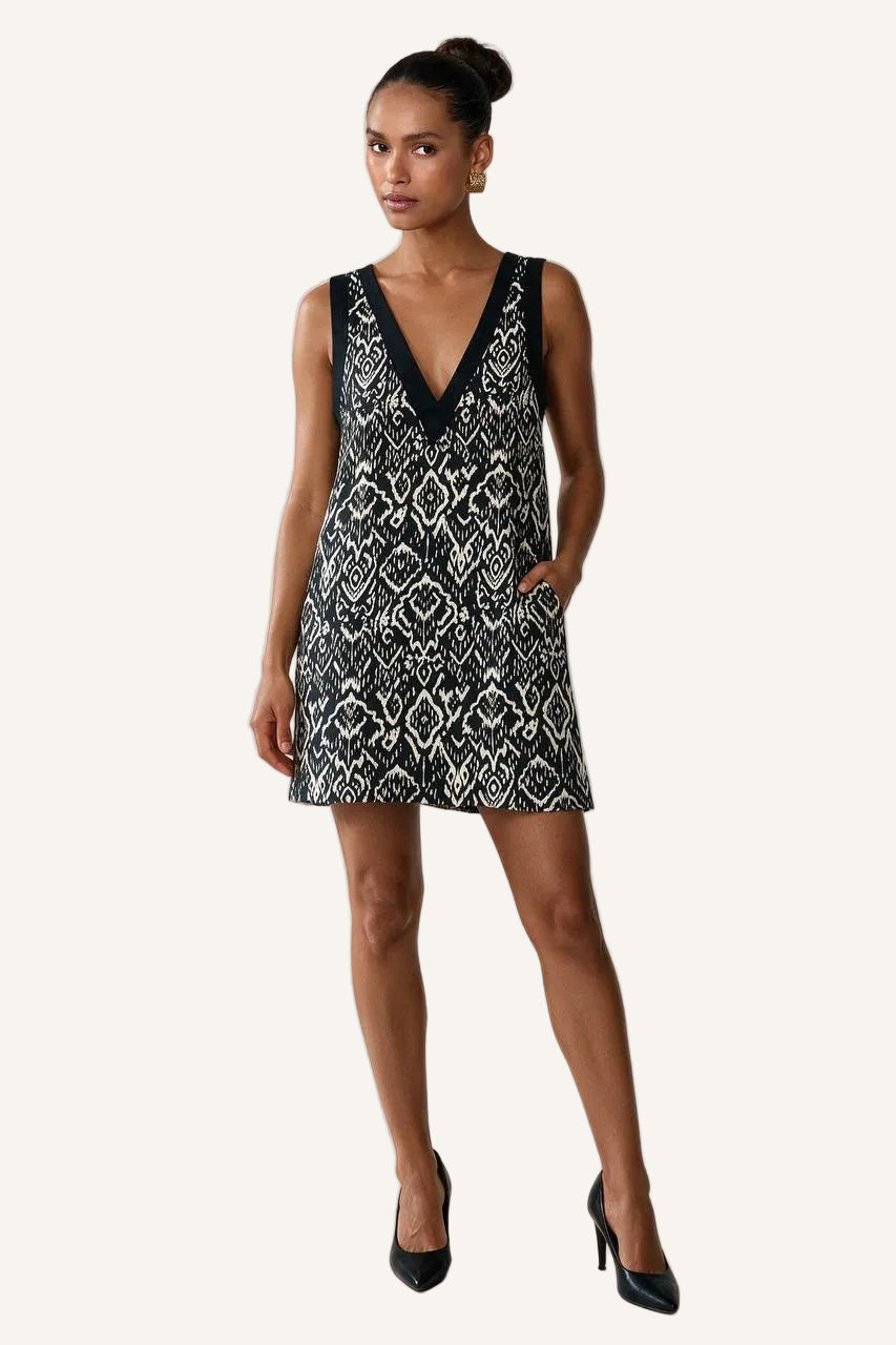 Bohemian Noir reversible linen mini dress in black and white print, deep V front with black trim and side pockets