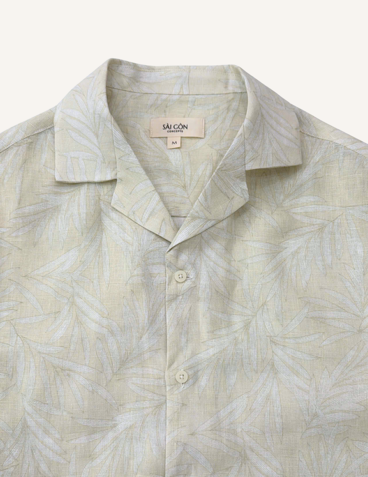Close-up of camp collar on ivory linen Hawaiian shirt with tonal white palm leaf print
