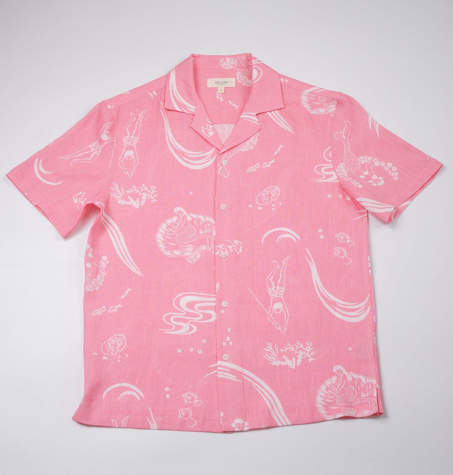 Saigon Concepts Coral Dream 100% Linen Hawaiian Shirt a pink base fabric with while drawn etchings of mermaids, fish and surfers - full front flat view